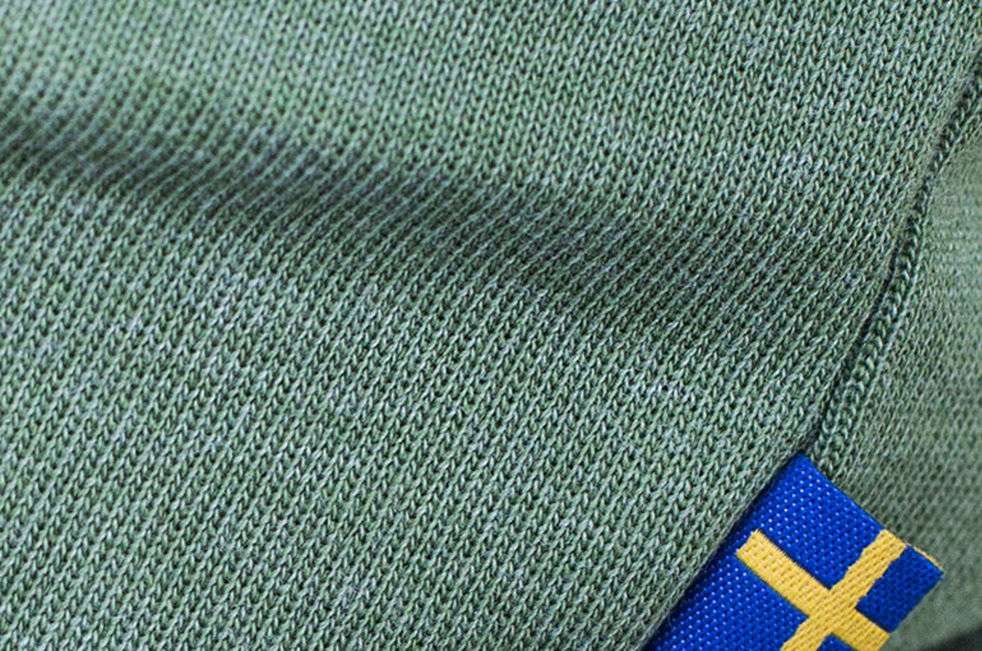 Closeup of fabric showing stitched swedish flag